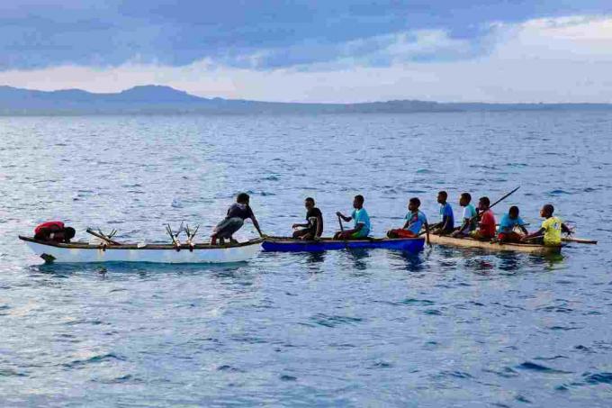 Hombres jóvenes en canoas en el noroeste de Malakula, Vanuatu.