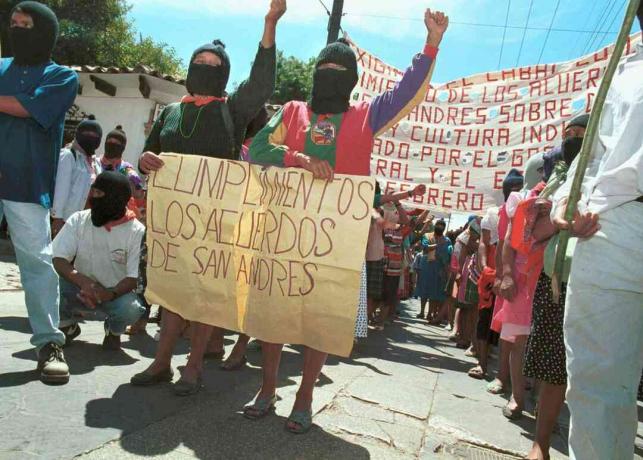 Dos mujeres sostienen un cartel que insta al gobierno a cumplir con los Acuerdos de San Andrés